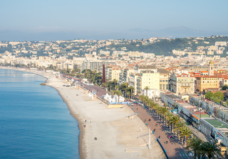 NICE - APRIL 9 : Cityscape view of Nice in France,  beach along Mediterranean sea, buildings and local road, under morning light, on April 9, 2017.のeditorial素材