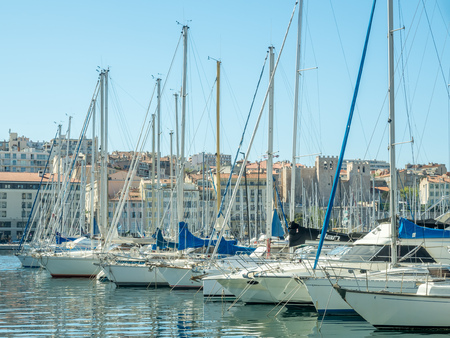 MARSEILLE - APRIL 11 : Old port of Marseille with Basilica of Our Lady of the Guard catholic church in background, crowded with luxury yachts, in Marseille, France, on April 11, 2017.のeditorial素材
