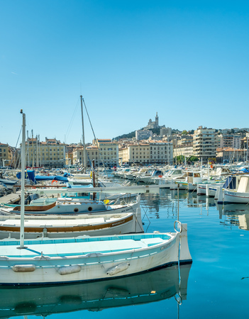 MARSEILLE - APRIL 11 : Old port of Marseille with Basilica of Our Lady of the Guard catholic church in background, crowded with luxury yachts, in Marseille, France, on April 11, 2017.のeditorial素材