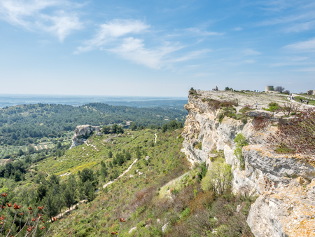 Landscape view of cultivated field from Chateau des Baux-de-provence in France under cloudy blue skyの写真素材