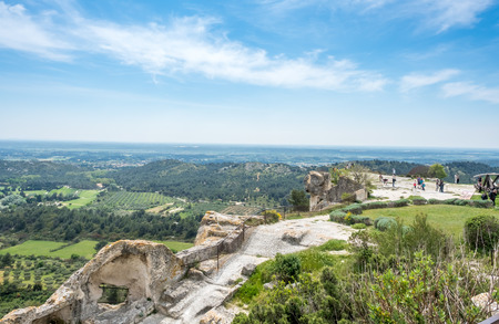 Landscape view of cultivated field from Chateau des Baux-de-provence in France under cloudy blue skyの写真素材