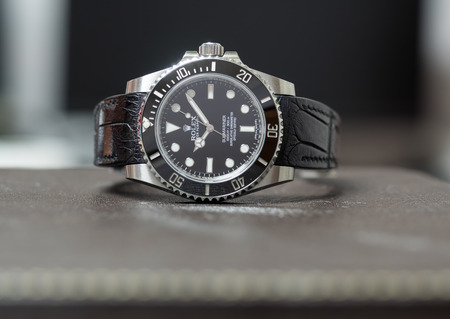 BANGKOK - SEPTEMBER 24 : Rolex submariner no date model with ceramic bezel, the most popular luxury watch, and alligator leather strap on leather surface table, was taken on September 24, 2017, in Bangkok, Thailandのeditorial素材