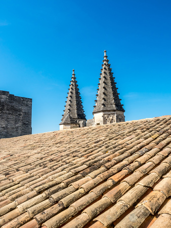 Architecture of roof top, tiles and sharp domes of Papal palace (Palais des Papes) under clear blue sky in Avignon, Franceの写真素材
