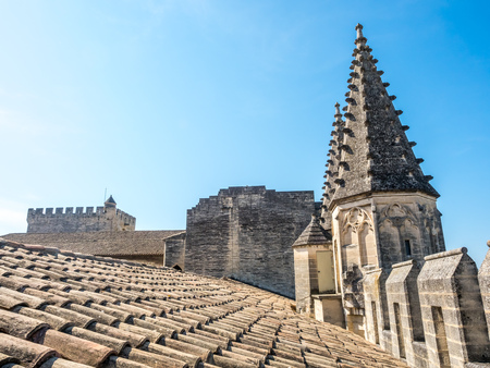 Architecture of roof top, tiles and sharp domes of Papal palace (Palais des Papes) under clear blue sky in Avignon, Franceの写真素材