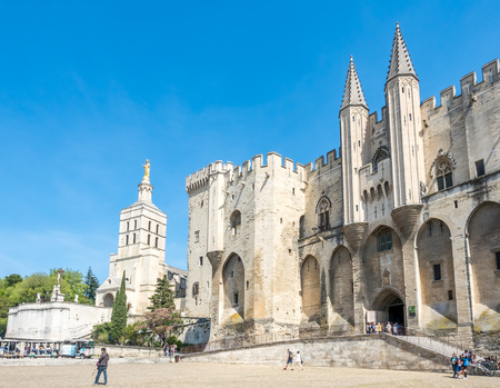 Avignon cathedral (Cathedral of Our Lady of Doms) next to Papal palace (Palais des Papes)  under clear blue sky in Avignon, Franceのeditorial素材