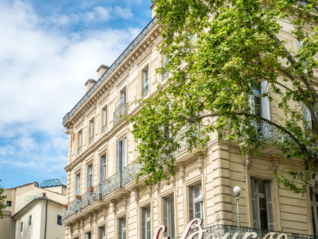 Building in Nimes, France, under cloudy blue skyのeditorial素材