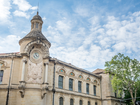 Clock tower building in Nimes, France under cloudy, blue skyのeditorial素材