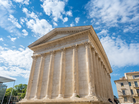 Maison Carree, mean square house in French, ancient Roman temple in Nimes, France, under cloudy blue skyのeditorial素材