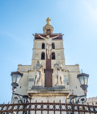 Avignon cathedral (Cathedral of Our Lady of Doms) next to Papal palace (Palais des Papes)  under clear blue sky in Avignon, Franceのeditorial素材