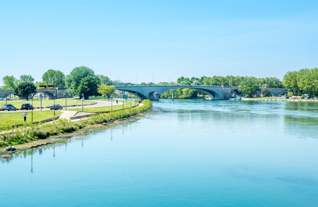 Rhone river view from Pont d'Avignon destroyed half bridge under cloudy blue sky in Avignon, Franceのeditorial素材