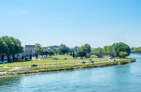 Rhone river view from Pont d'Avignon destroyed half bridge under cloudy blue sky in Avignon, Franceのeditorial素材
