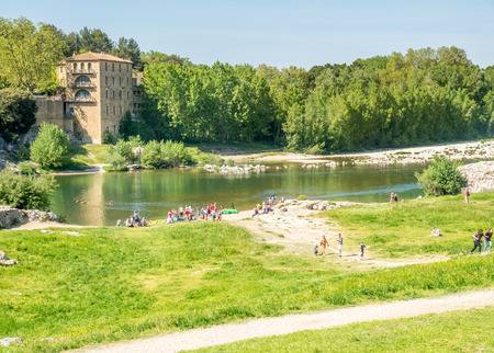 Gardon river beneath Pont du Gard, ancient Roman aqueduct, under blue sky in Nimes, Franceの写真素材