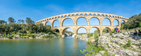 NIMES, FRANCE - APRIL 12 : Tourists travel in Pont du Gard, ancient Roman aqueduct, crosses Gardon river, Nimes, France, on April 12, 2017.のeditorial素材