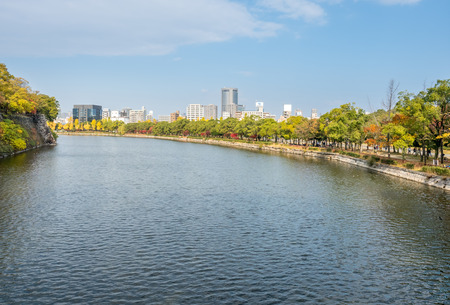 OSAKA, JAPAN - OCTOBER 23 : Colorful autumn trees in outdoor park near Osaka castle with canal in Osaka, Japan, on October 23, 2017.のeditorial素材