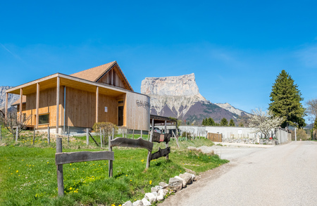 Buildings of house in Chichilianne town, small town in valley, countryside of France, under clear blue sky in spring season, with mount Aiguille in backgroundのeditorial素材