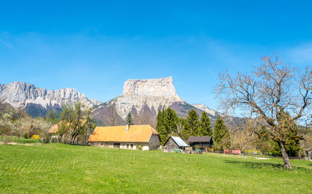 Buildings of house in Chichilianne town, small town in valley, countryside of France, under clear blue sky in spring season, with mount Aiguille in backgroundのeditorial素材