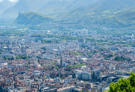 Cityscape view of Grenoble city, from Basille hill and fortress in France, under cloud skyの写真素材