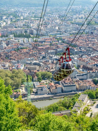 GRENOBLE, FRANCE - APRIL 13 : Grenoble-Bastille cable car, four bubbles on sling, transport to hill and fortress of Bastille cross Isere river in Grenoble, France, was taken on April 13, 2017.のeditorial素材