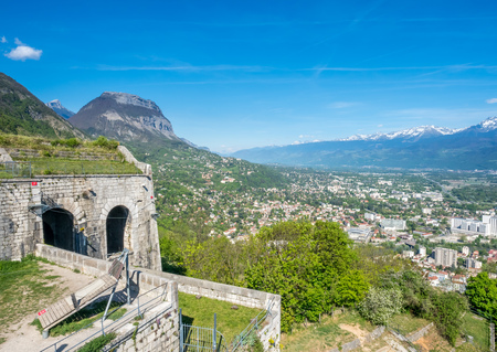 Cityscape view of Grenoble city, from Basille hill and fortress in France, under cloud skyの写真素材
