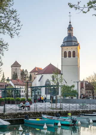 ANNECY, FRANCE - APRIL 13 : Tower and building of church of St.Maurice, near canal in Annecy, France, under evening twilight sky on April 13, 2017.のeditorial素材
