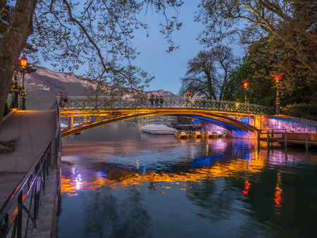 ANNECY, FRANCE - APRIL 13 : Pont d'Amour, known as Lovers' bridge, landmark at shore of lake in Annecy, France, in twilight evening, on April 13, 2017.のeditorial素材