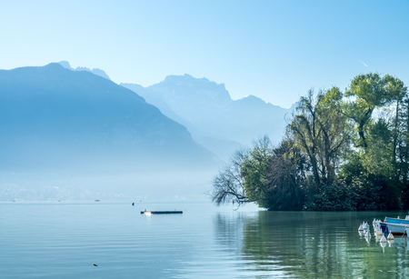 Lake and mountains in Annecy, France ,under morning clear blue skyの写真素材
