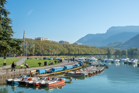 ANNECY, FRANCE - APRIL 14 : Boats dock in lake with mountain view in background in Annecy, France, on April 14, 2017.のeditorial素材