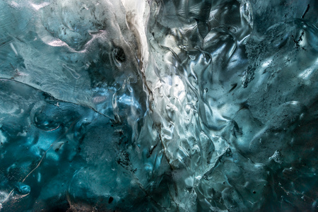 Ice cave located beneath glacier among ice mountain in Iceland, it is mesmerizing landmark.の写真素材