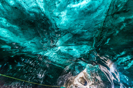 Ice cave located beneath glacier among ice mountain in Iceland, it is mesmerizing landmark.の写真素材