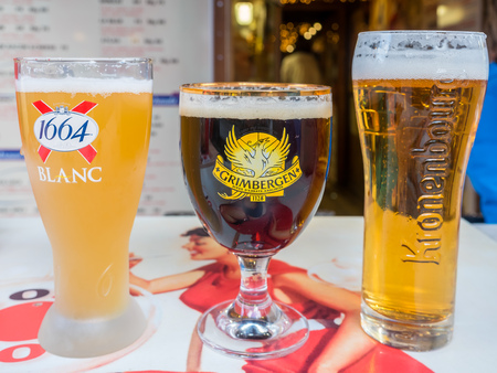 CHAMONIX-MONT-BLANC, FRANCE - APRIL 15 : Three unique glasses of draught beer, 1664 Blanc, Grimbergen and Krongenbourg, at front of Poco Loco burger shop in Chamonix Mont Blanc town in France, on April 15, 2017.のeditorial素材