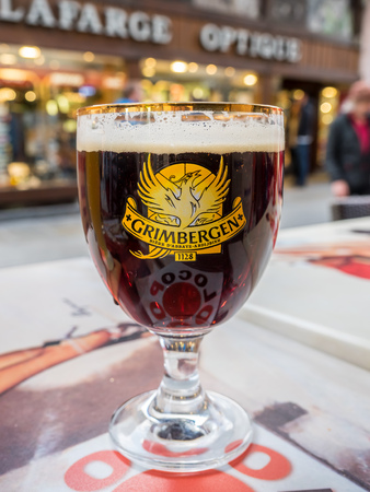 CHAMONIX-MONT-BLANC, FRANCE - APRIL 15 : Grimbergen draught dark beer in unique glass on outdoor table in Poco Loco burger shop in Chamonix Mont Blanc town, France, on April 15, 2017.のeditorial素材