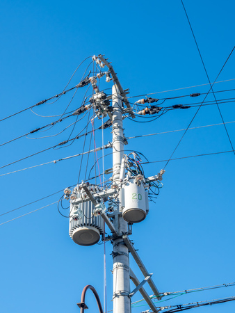 Electricity pole with light lantern under blue sky
