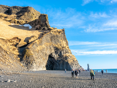 Reynisfjara black sand beach is landmark of Vik town in Iceland, surrounded with basalt mountains, under blue sky in winter seasonのeditorial素材