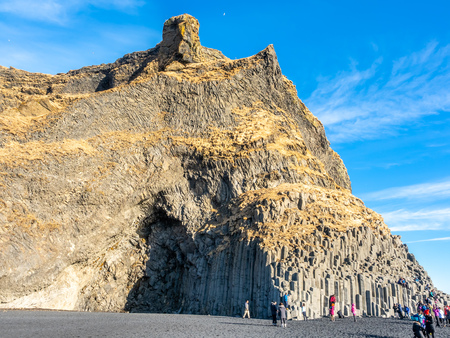 Reynisfjara black sand beach is landmark of Vik town in Iceland, surrounded with basalt mountains, under blue sky in winter seasonのeditorial素材