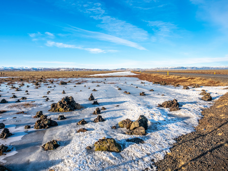 LaufskÃ¡lavarÃ°a, lava ridge between river, surrounded with stone cairns, just side of golden ring road in Iceland. In winter season, field becomes ice and snow.の写真素材