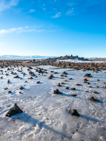 LaufskÃ¡lavarÃ°a, lava ridge between river, surrounded with stone cairns, just side of golden ring road in Iceland. In winter season, field becomes ice and snow.の写真素材
