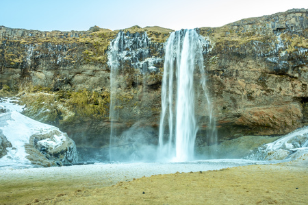 Siljalandsfoss waterfall, one of landmark in Iceland, large waterfall with natural cliff in winter season with snow and ice aroundの写真素材