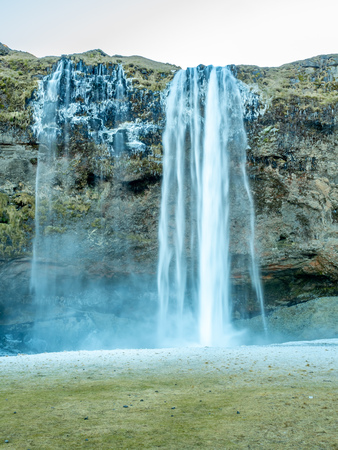 Siljalandsfoss waterfall, one of landmark in Iceland, large waterfall with natural cliff in winter season with snow and ice aroundの写真素材