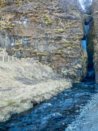 Large waterfall near Seljalandsfoss waterfall with large snow on rock in south side of Iceland, in winter seasonの写真素材