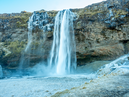 Siljalandsfoss waterfall, one of landmark in Iceland, large waterfall with natural cliff in winter season with snow and ice aroundの写真素材