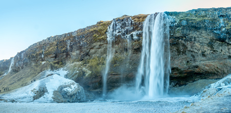 Siljalandsfoss waterfall, one of landmark in Iceland, large waterfall with natural cliff in winter season with snow and ice aroundの写真素材