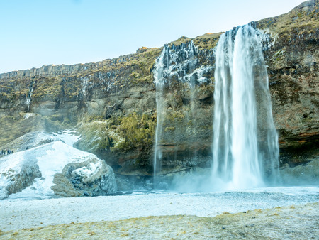 Siljalandsfoss waterfall, one of landmark in Iceland, large waterfall with natural cliff in winter season with snow and ice aroundの写真素材
