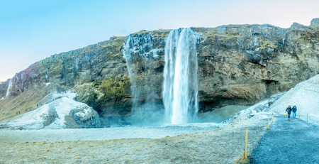 ICELAND - MARCH 3 : Siljalandsfoss waterfall, one of landmark in Iceland, large waterfall with natural cliff in winter season with snow and ice around on March 3, 2018.のeditorial素材