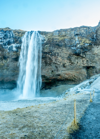 Siljalandsfoss waterfall, one of landmark in Iceland, large waterfall with natural cliff in winter season with snow and ice aroundの写真素材