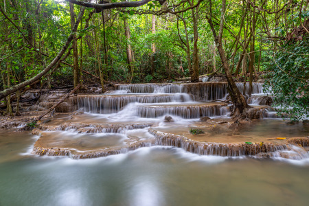 Stepping waterfall with flowing water effect in forest of Thailandの写真素材