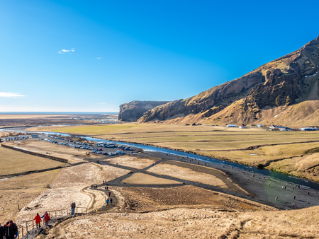 Mountains, hills, meadow and field near Skogafoss waterfall in winter season in Icelandの写真素材