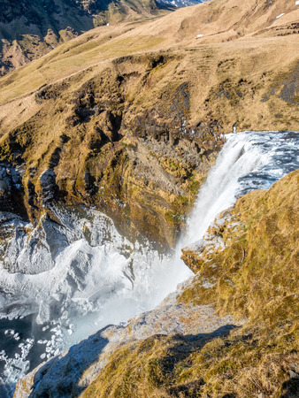Top view of Skogafoss waterfall with snow and ice in winter season in Icelandの写真素材
