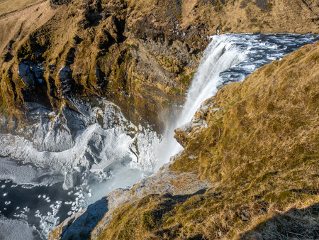 Top view of Skogafoss waterfall with snow and ice in winter season in Icelandの写真素材