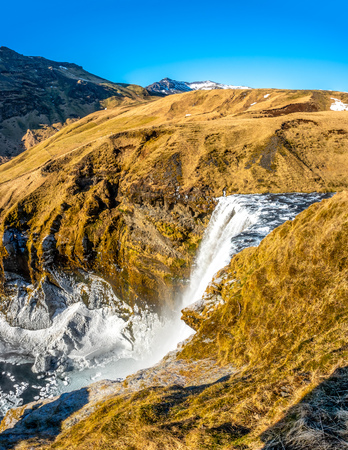 Top view of Skogafoss waterfall with snow and ice in winter season in Icelandの写真素材