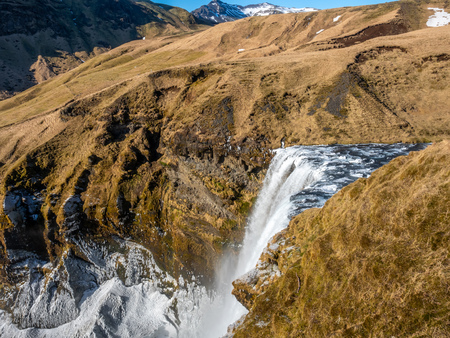 Top view of Skogafoss waterfall with snow and ice in winter season in Icelandの写真素材